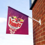 standard_flag_kit_mounted_outside_on_a_brick_wall_advertising_vimto